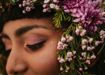 close up of floral veil and colourful makeup on brides face
